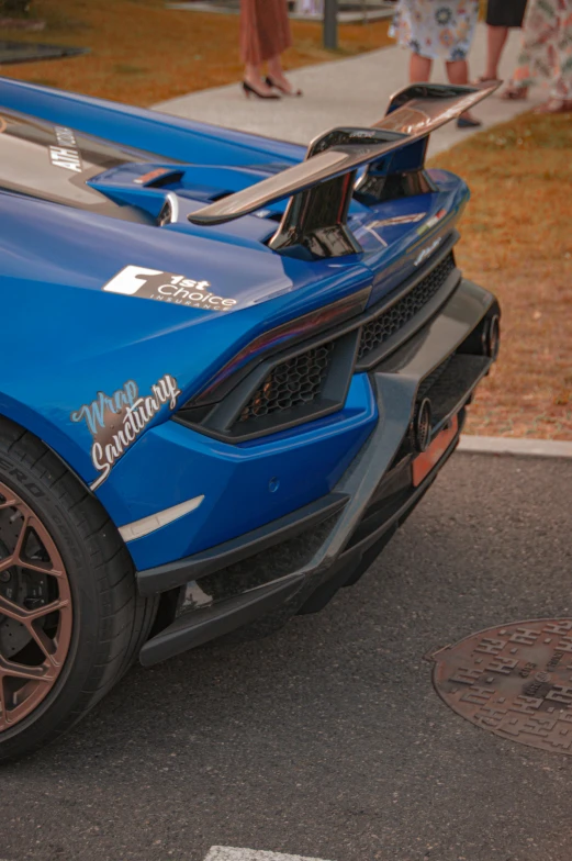 a blue race car parked on the side of a road