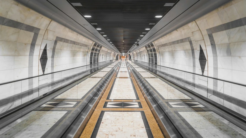 people are traveling down an escalator in an underground train station