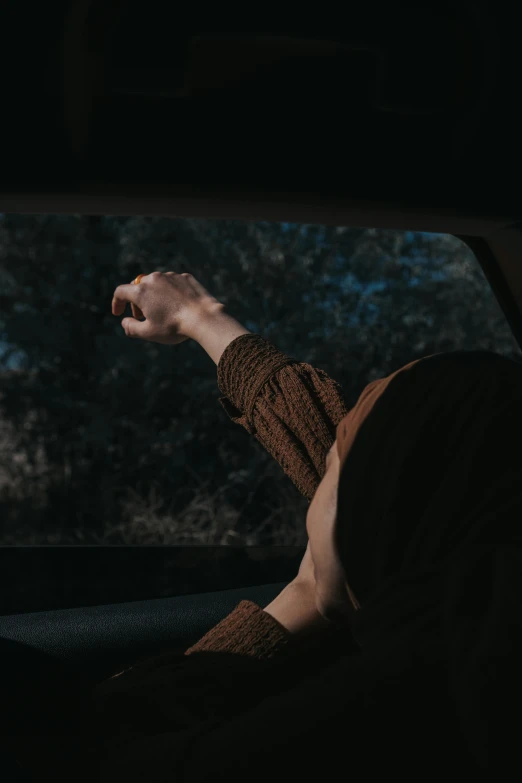 a shirtless man driving a vehicle through a wooded area