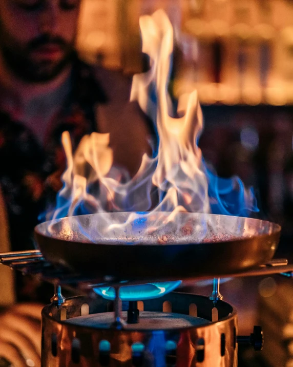 blue flames over an oil pot cooking food