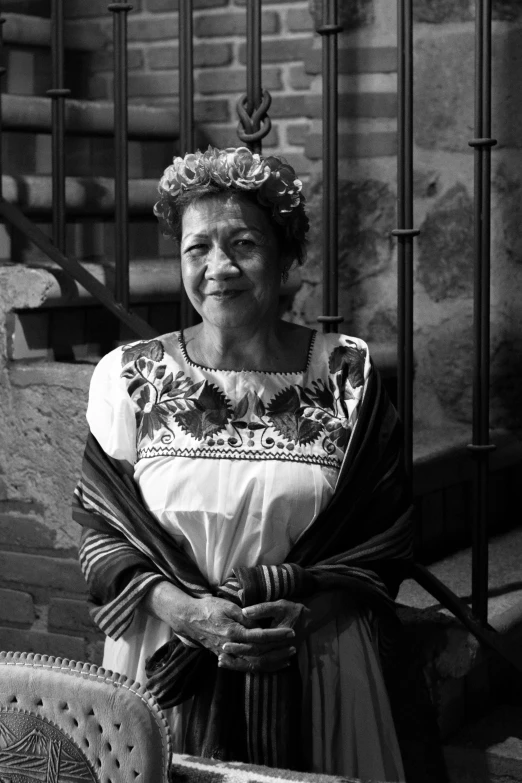 a woman wearing a tiara and sitting in a chair