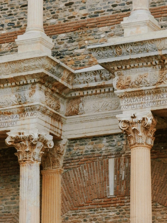 a close up of three pillars, one with decorative carvings on it