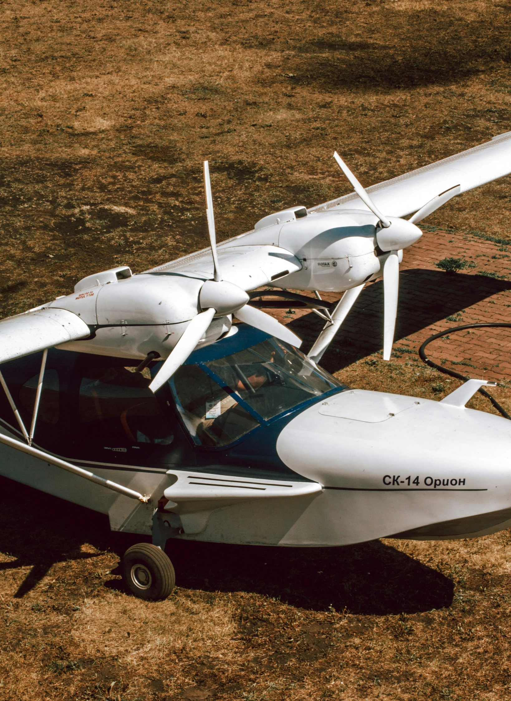 a white helicopter parked on top of a grass field