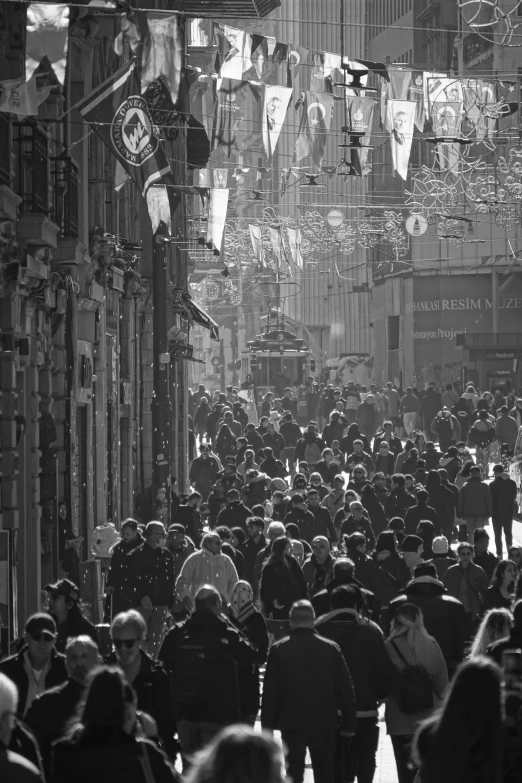 a busy city street full of people and lots of buildings