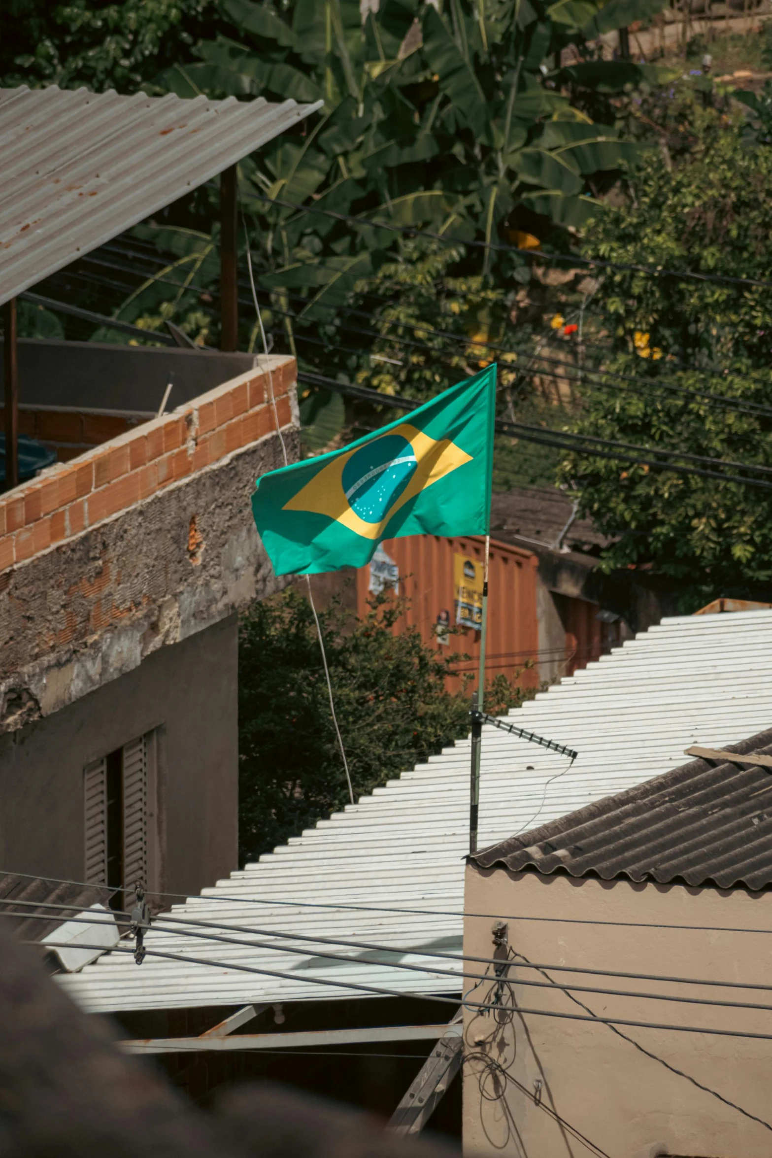 a flag flies in the wind next to buildings