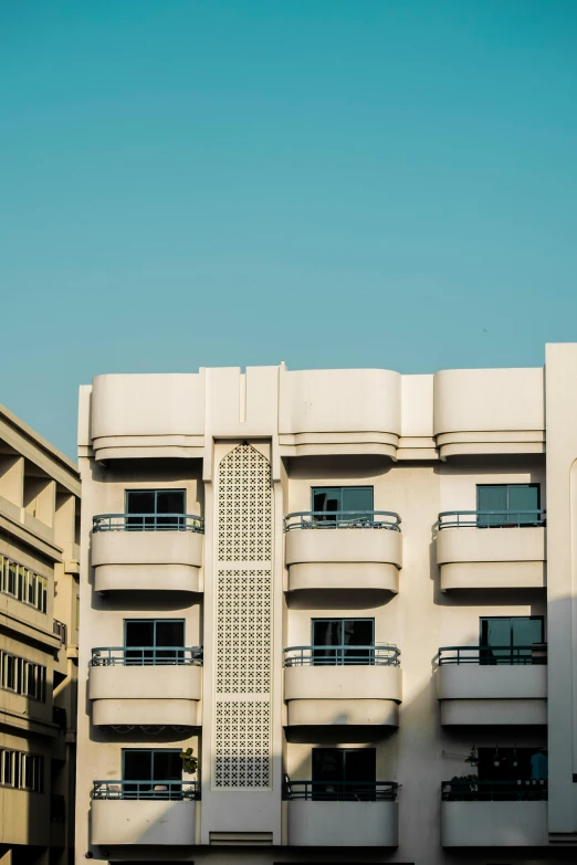 a tall building with many balconies on top