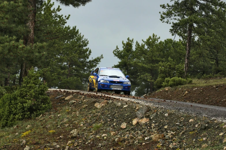 a blue car is driving up a hill