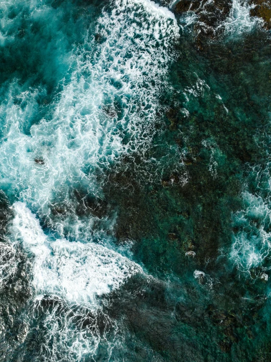 a bird view of some water and a beach