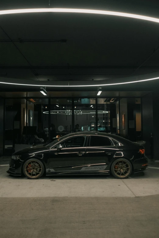 a black car parked inside of a building