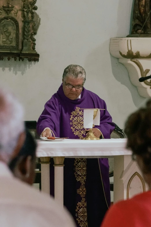 a priest reading a note in his church