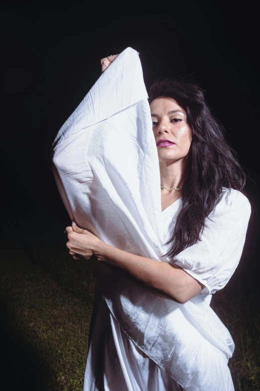 a woman is wrapped in white cloth outside