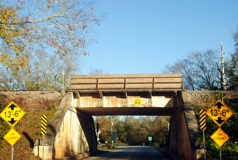 a view of the highway overpass with yellow signs on it