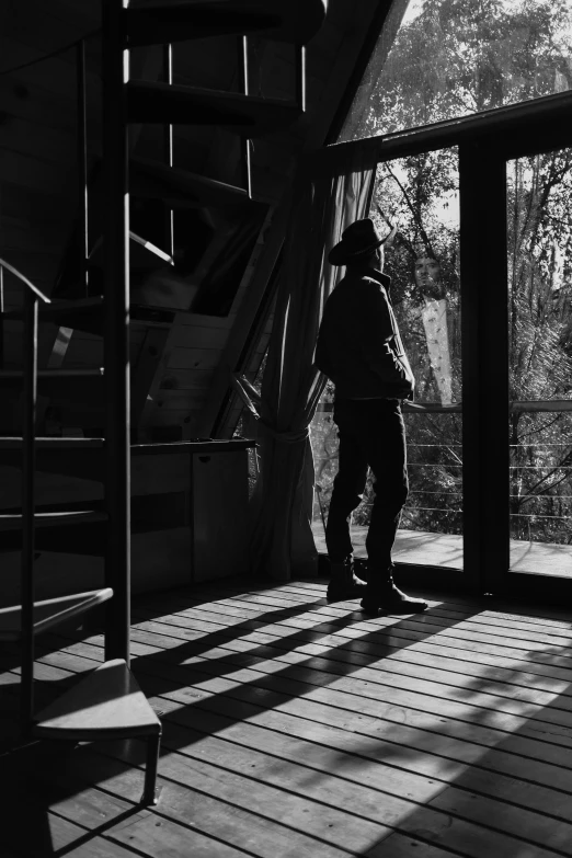 a person standing in the shadows next to stairs