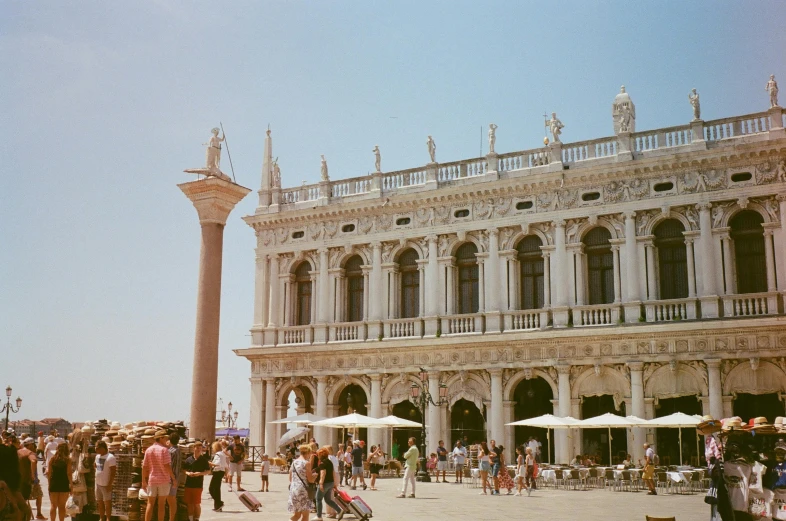 people in front of a big building with lots of arches