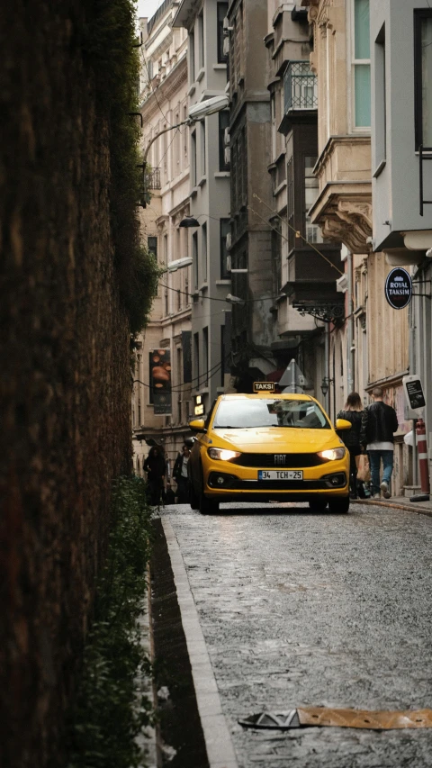 a yellow taxi cab sitting on the side of a road