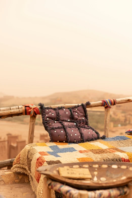 a patchwork quilted chair next to a large wooden cane