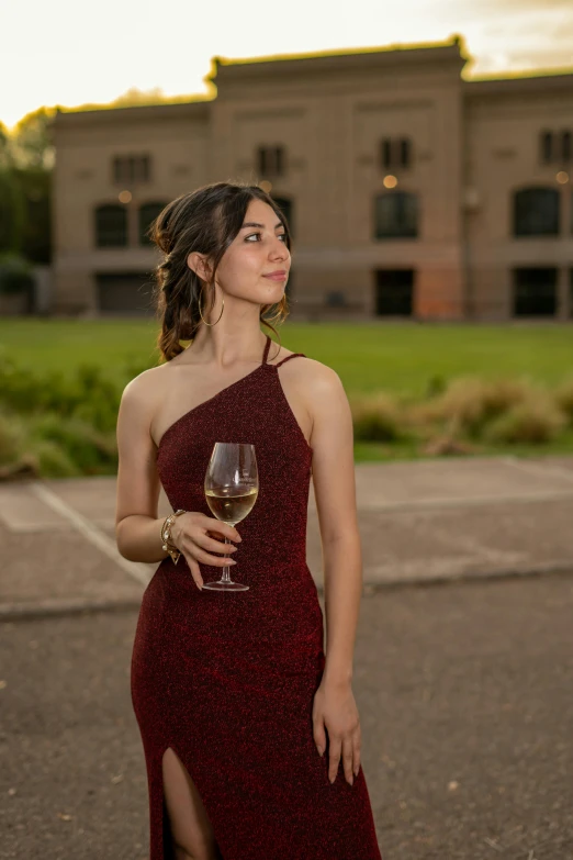 a woman wearing a red dress with a wine glass in her hand