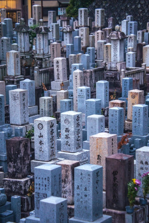 a view of rows of graves with chinese writing on them