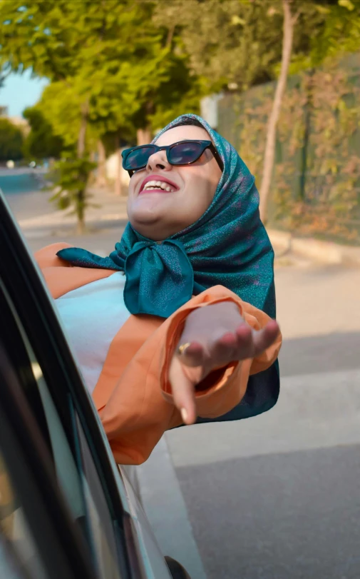 a person in a scarf taking a selfie