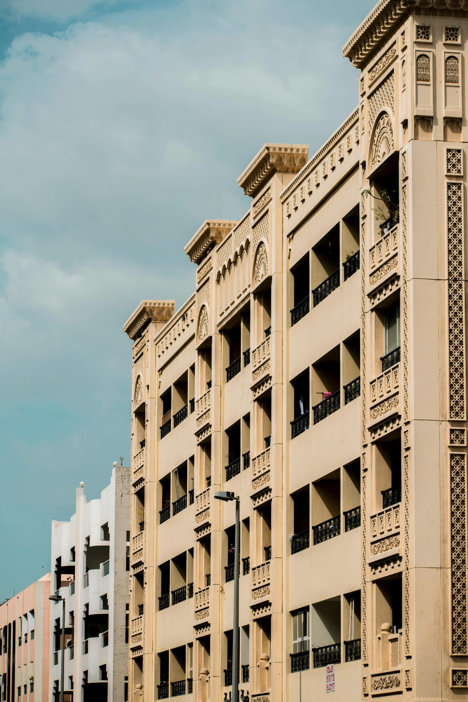 a big building with decorative carvings near the road