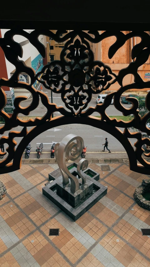 the view through an arch into a courtyard