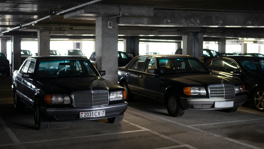 several cars are lined up in a parking garage