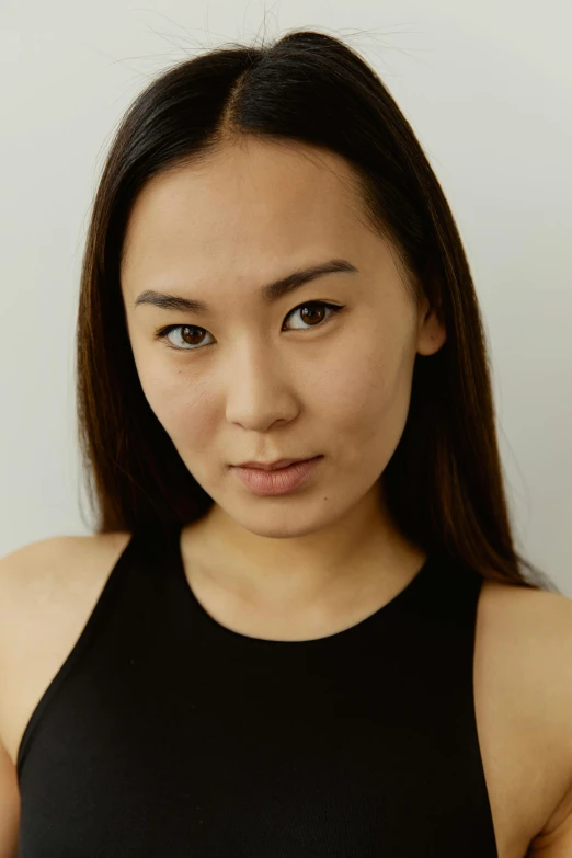 an asian woman in a black tank top with dark hair