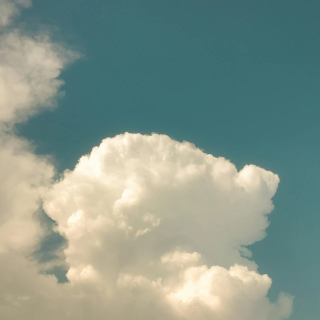 a jet is flying through the sky on a cloudy day