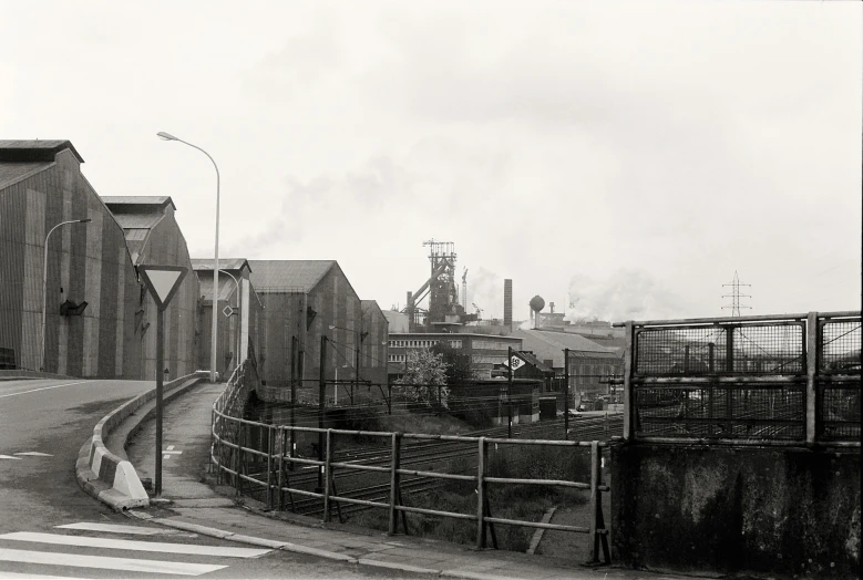 some buildings smokes steam on a cloudy day