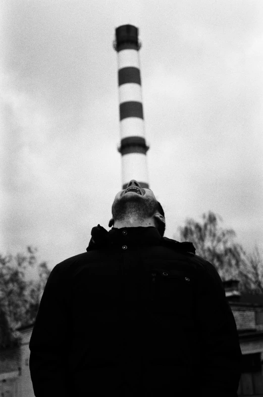 a man is standing in front of a light house