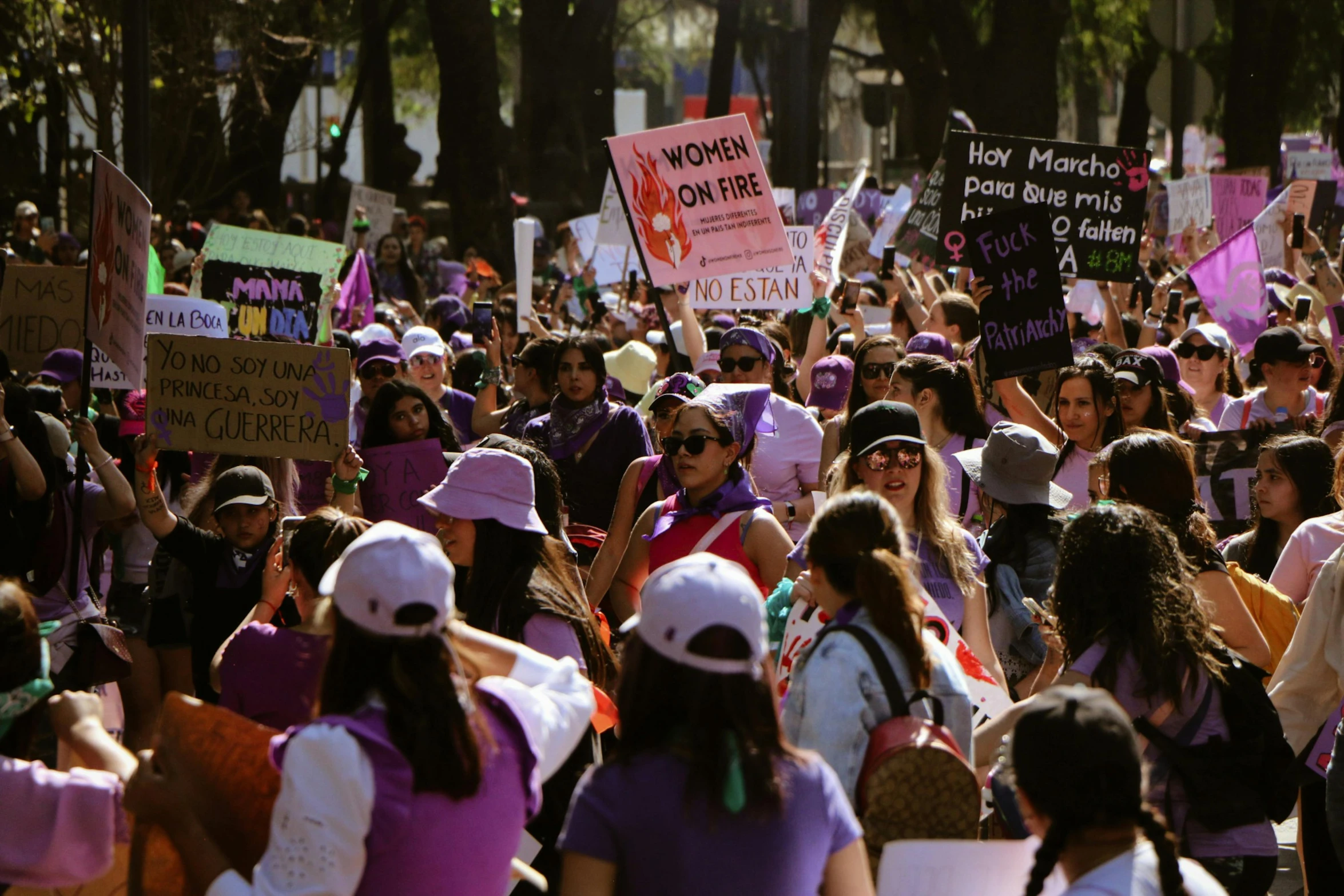 people are lined up with signs and hats