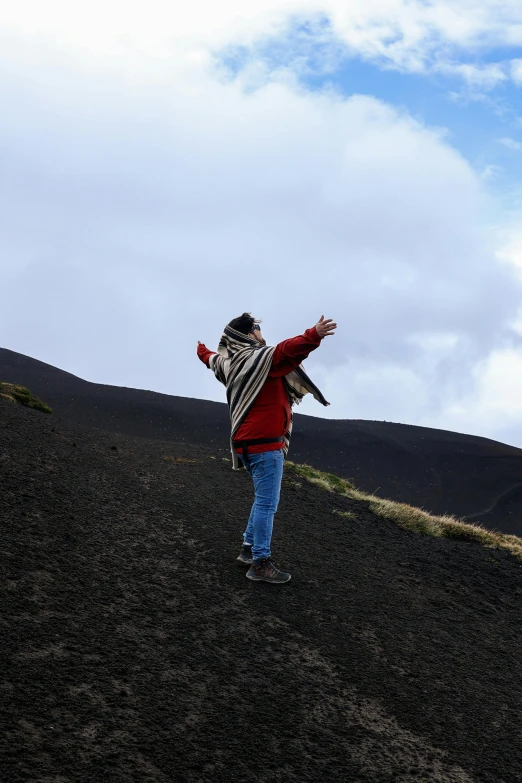 a man flying his kite on a hill