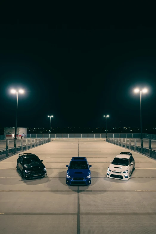 four cars parked at the end of a parking lot