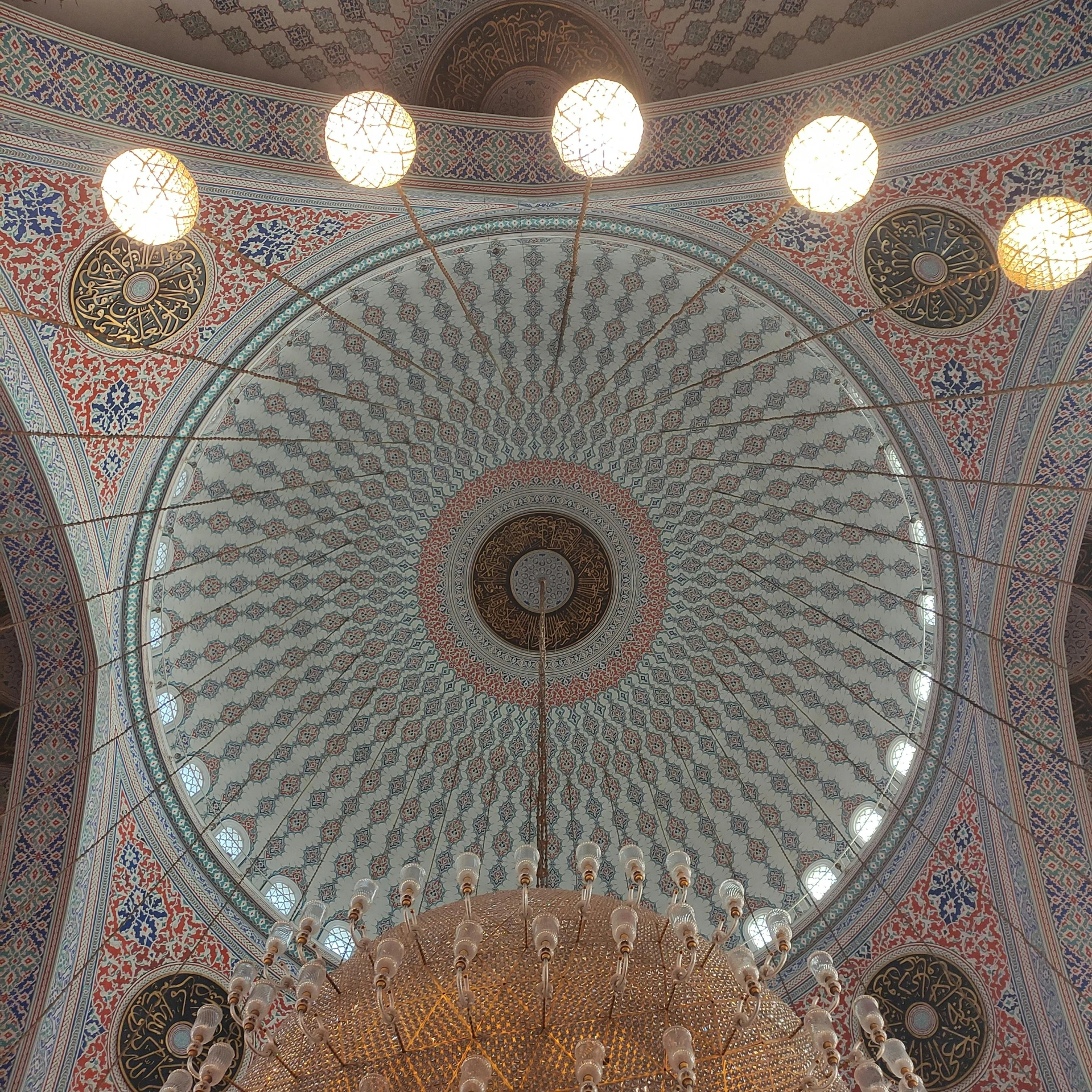 this intricate ceiling is surrounded by many round holes and lights