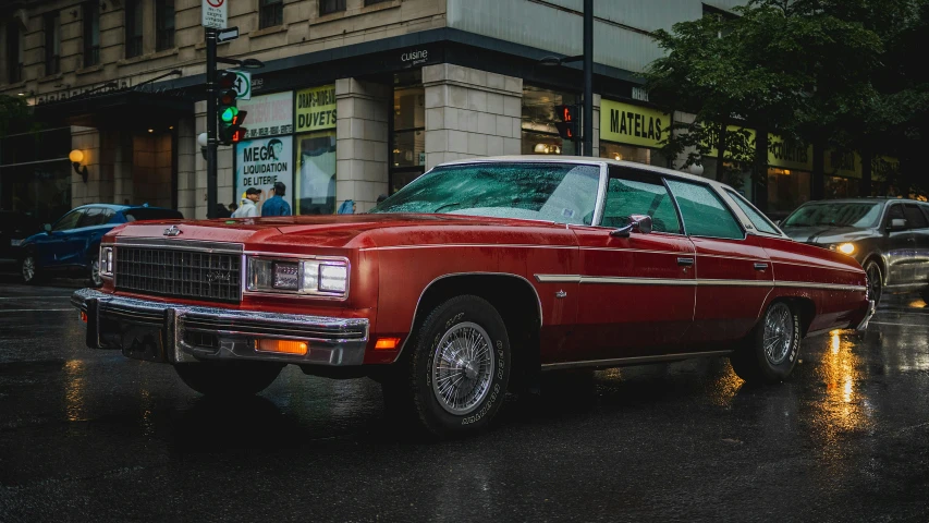 a red car parked in front of a tall building