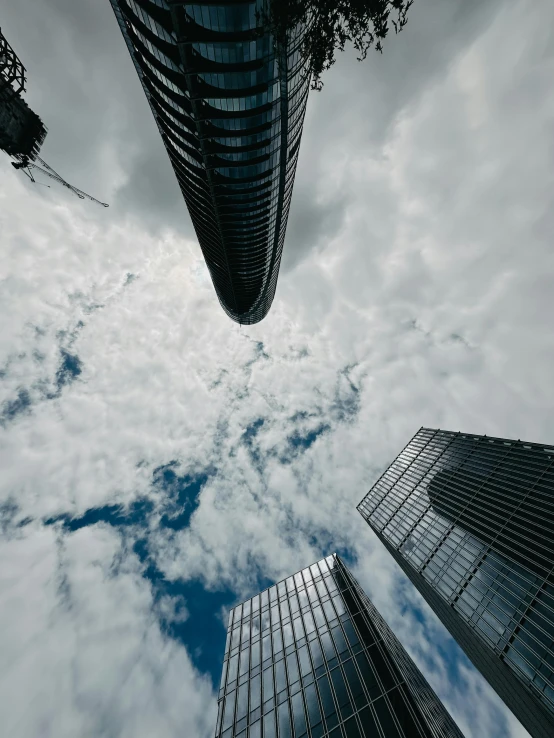 two skyscrs in front of a cloudy blue sky