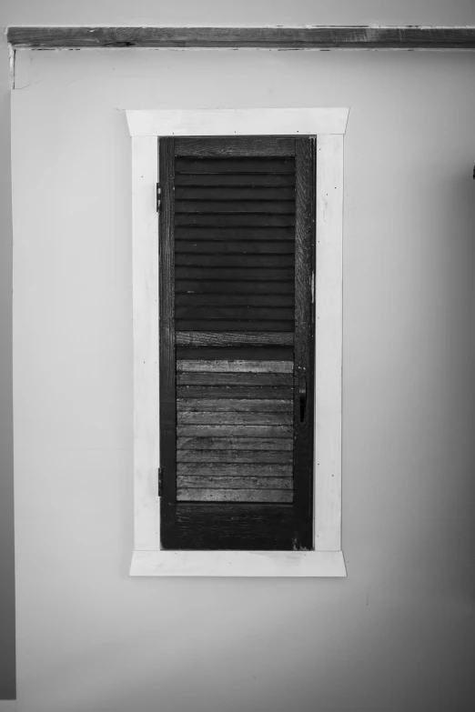 black and white po of shutters in an open window