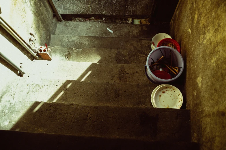 a bucket and some food near stairs