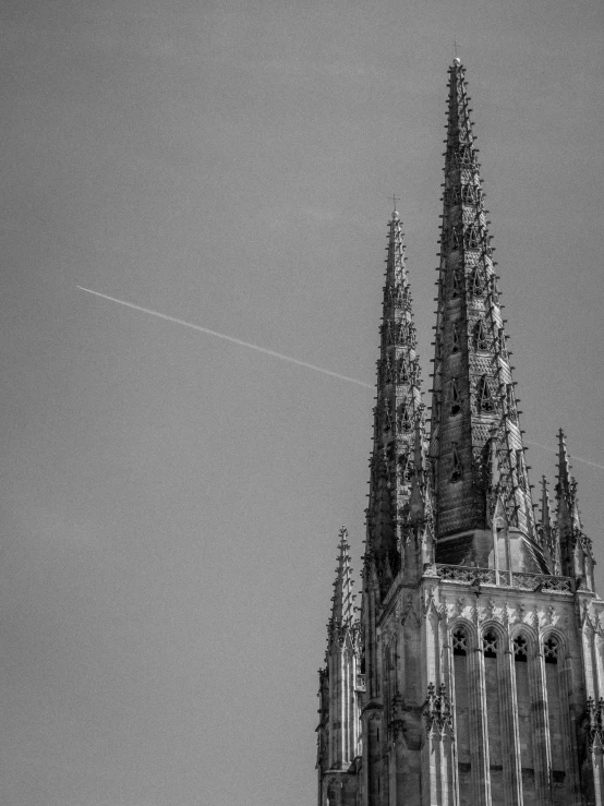 the view of a tall cathedral spire, in black and white