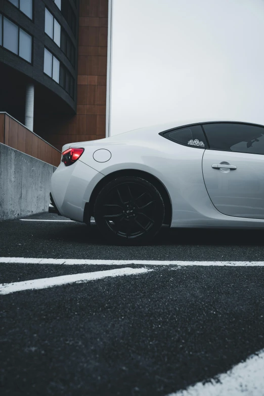 a white sports car sitting on the side of the road