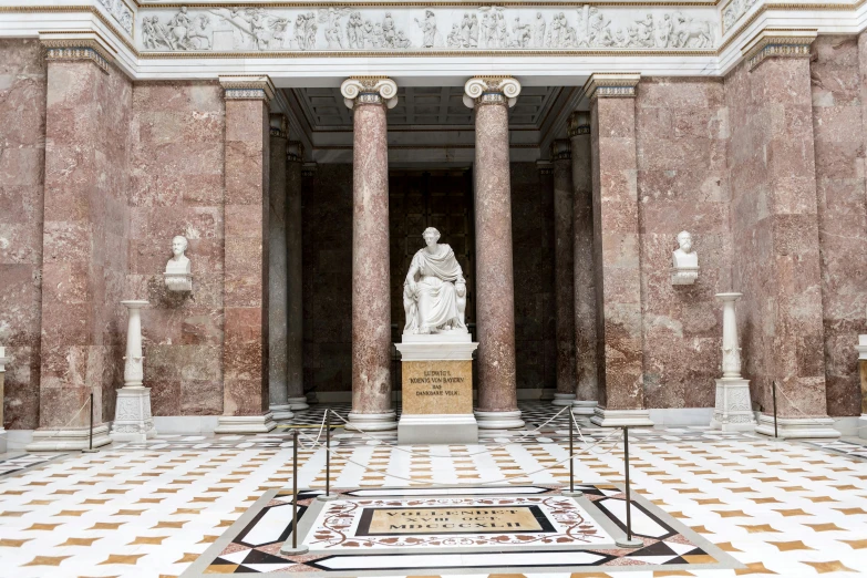 a small statue is in the middle of a hallway