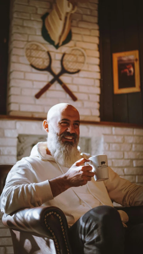 a man with long white hair holding up a cup