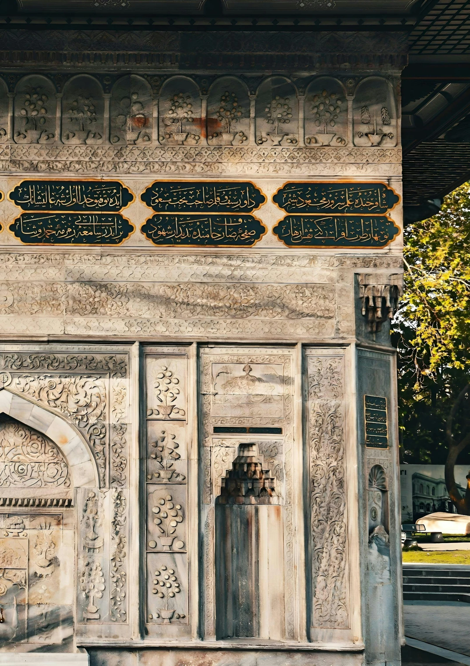 an ornate, old, stone memorial in an urban setting