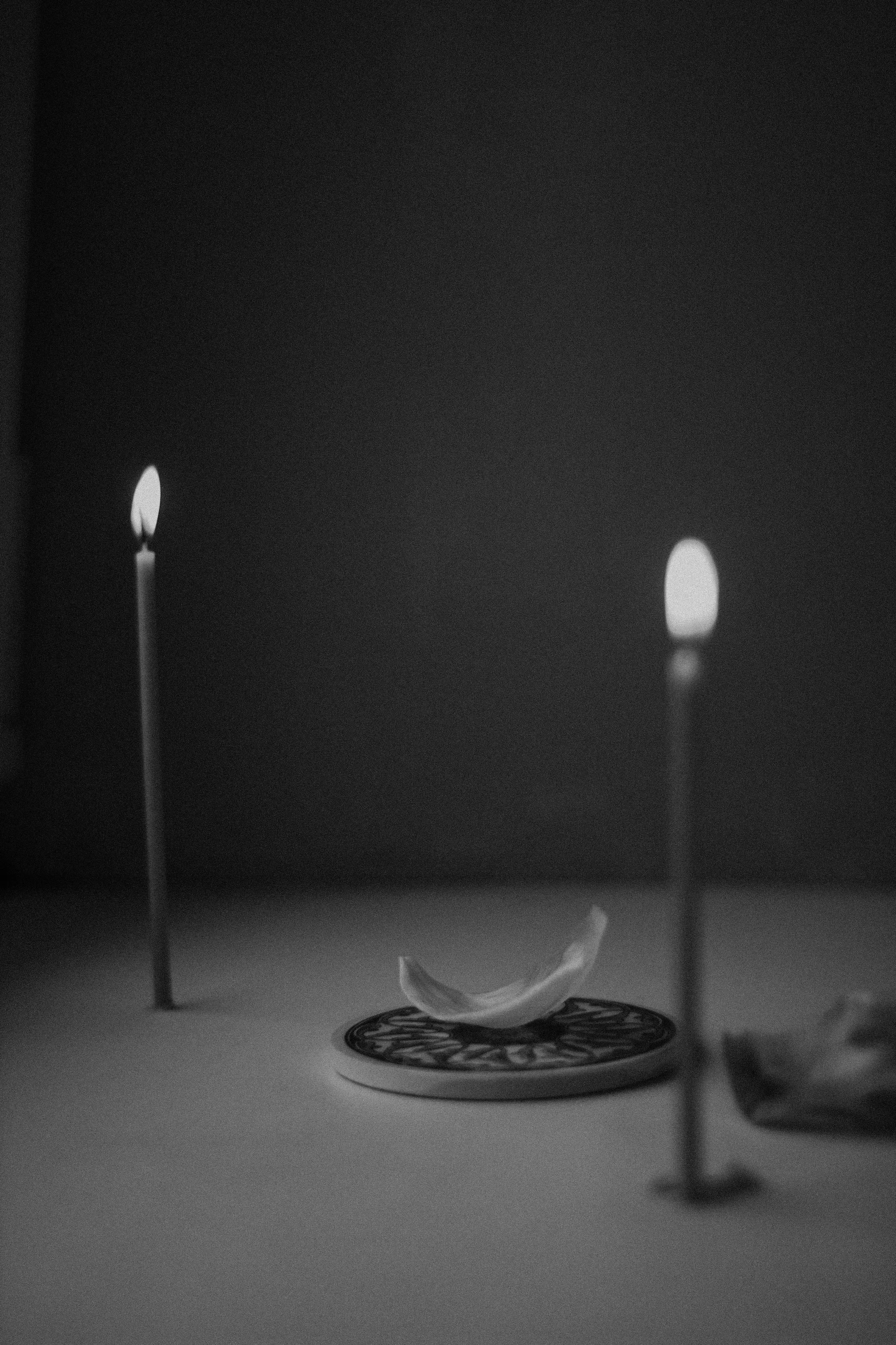 there are two candles next to an object that has no lights