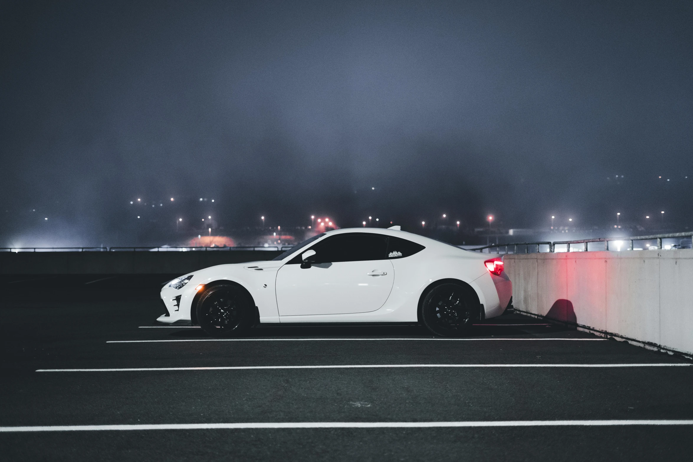 a white car is parked at the curb