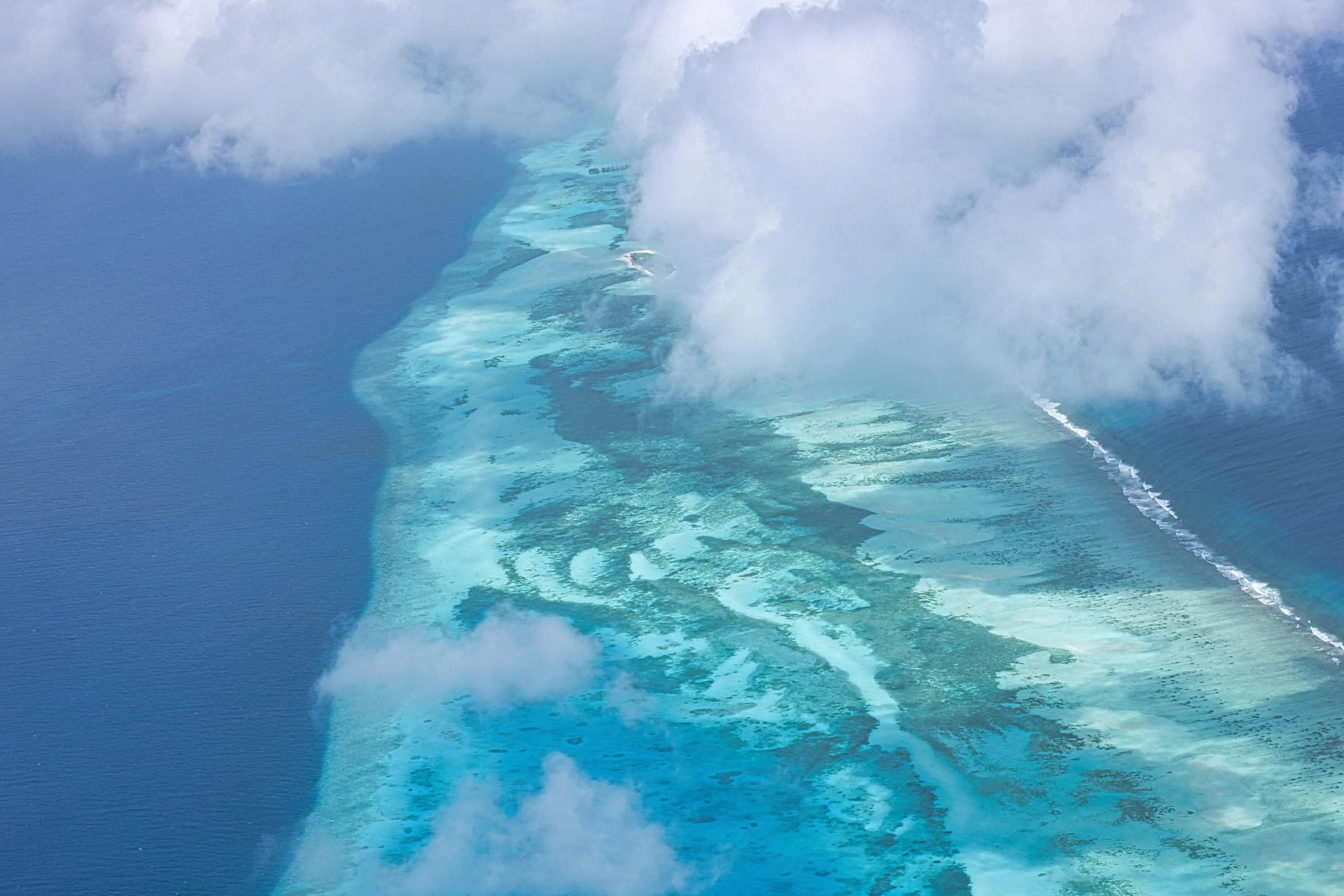 a long strip of blue water with clouds in it