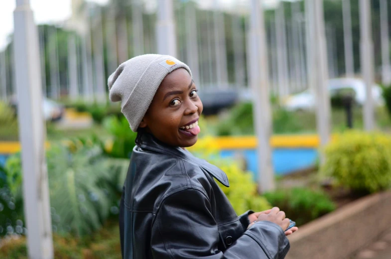 a young man with a white hat making a funny face