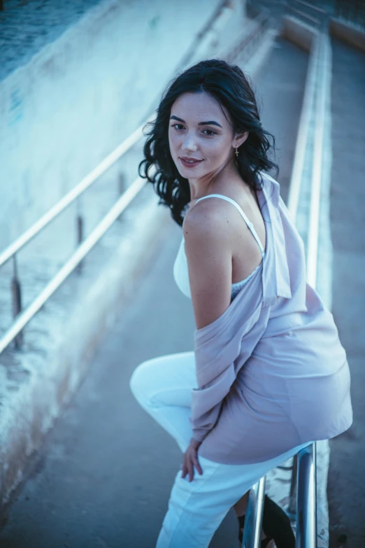 a woman sitting in a chair posing for the camera