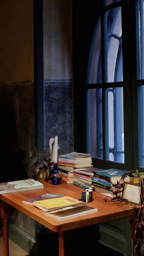 a desk in front of a large window