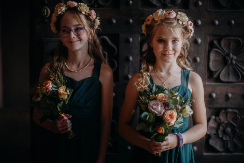 two girls posing with flower crowns for po